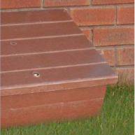 Semi-concealed meter box shown outside house